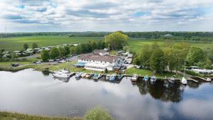 an aerial view of a house and boats on a river at Zum Alten Fährhaus - Bed & Breakfast in Wrohm