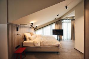 a bedroom with a bed and a tv in it at Ullrhaus in Sankt Anton am Arlberg
