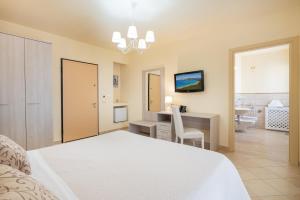 Postel nebo postele na pokoji v ubytování Hotel Regina Elena