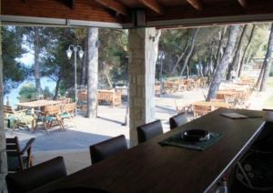 a dining room with a table and a view of a patio at Nostos Hotel in Afitos