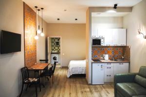 a kitchen and a living room with a couch and a table at Tomiris Lady's Capsul hostel only for women in Almaty