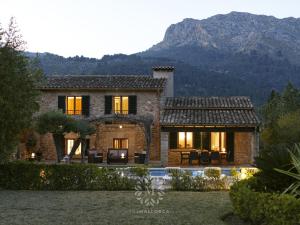 een huis met een berg op de achtergrond bij VILLA CAN PERIC WITH POOL Quiet and spacious in Pollença