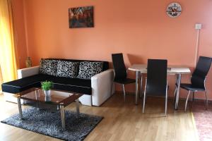 a living room with a couch and a table at Relaxing residence in Sibiu +28 photos
