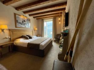 a bedroom with a bed and a large window at Al Molo 5 - Lake Front in Oliveto Lario