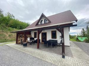 a small white house with a roof at Chata Slanica in Námestovo