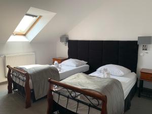 a bedroom with two beds and a window at Hotel Kameleon in Tarnobrzeg +31 photos