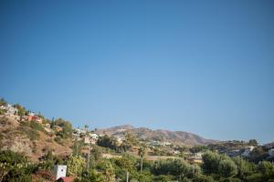 a view of a hill with houses and trees at H Boutique Peña Parda in La Herradura
