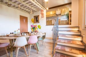 a dining room with a table and chairs and a staircase at B&B Botton d'Oro Valle Imagna in Fuipiano Valle Imagna