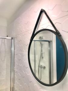 a mirror in a bathroom with a shower at Hôtel Café Miramar in Le Grau-du-Roi