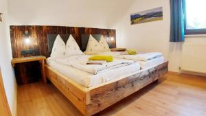 a large wooden bed in a room at Schirfhof in Michaelerberg
