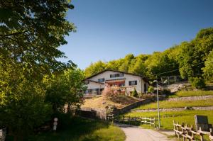 a house on a hill next to a dirt road at B&B Botton d'Oro Valle Imagna in Fuipiano Valle Imagna