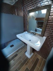 a bathroom with a sink and a mirror and a tub at Casa Santa in Calvi