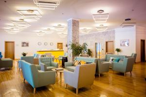 a waiting room with couches and chairs in a hospital at Gistola Hotel Mestia in Mestia