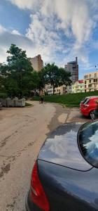 a car parked on a dirt road in a city at APARTMENT 075 TUZLA in Tuzla