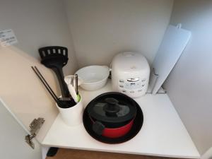 a kitchen counter with a blender and other kitchen utensils at Claska Ishigaki in Ishigaki Island