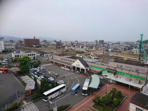 an overhead view of a city with buses and cars at Terminal Hotel Matsuyama in Matsuyama