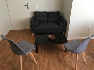 a living room with two chairs and a couch at Centre Jean XXIII in Annecy