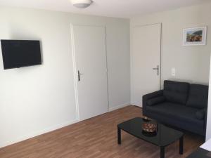 a living room with a couch and a table at Centre Jean XXIII in Annecy
