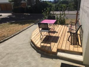 a table and two chairs on a wooden deck at Centre Jean XXIII in Annecy