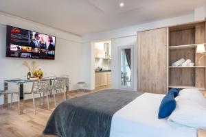a bedroom with a large bed and a dining room at Ocean Vistas 24 in Puerto de la Cruz +68 photos