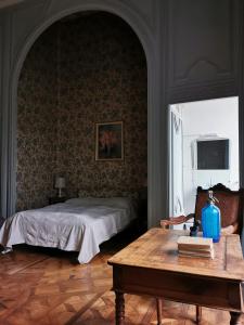 a bedroom with a bed and a table with a table sidx sidx sidx at Château de Chasseneuil sur Bonnieure in Chasseneuil-sur-Bonnieure +27 photos