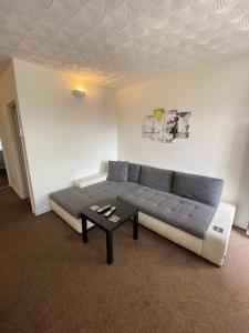 a bedroom with a bed and a coffee table at The Castle Lodge in Tredegar