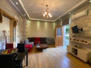 a living room with a couch and a table at Barbara Studios in Rethymno