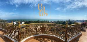 a balcony with a gold railing with a view at Paris Hotel Bình Thuận in Tuy Phong