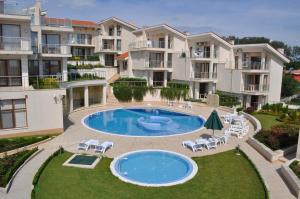an image of an apartment complex with a swimming pool at Beautiful family villa with sea view in Byala