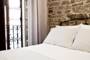 A bed or beds in a room at Sete Artes by Como en Casa