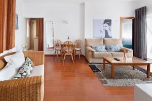 a living room with a couch and a table at Casino 5 in Carvoeiro