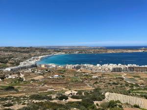 an aerial view of a city and the ocean at Hotel VIU57 in Mellieħa