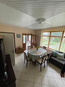 a living room with a table and chairs and a couch at Ágnes Nyaralóház in Balatonmáriafürdő