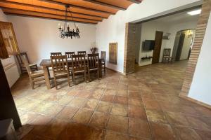 a large dining room with a table and chairs at CASA RURAL EL TRANCO DEL LOBO in Casas de Ves