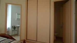 a bedroom with a door leading to a bathroom at Hotel La Vie En Rose in Le Brugeron +16 photos