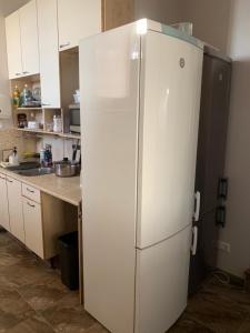 La cuisine est équipée d'un réfrigérateur blanc. dans l'établissement Rotermanni hostel 4Floor NO LIFT, à Tallinn