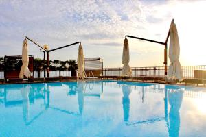 a swimming pool with a pool table and chairs at BO Hotel Palazzo in Poreč