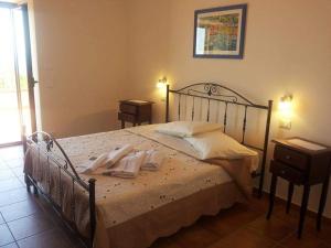 a bedroom with a bed with towels on it at Agriturismo Agri Armonia in San Lucido +90 photos