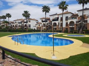 Bazén v ubytování Cozy apartment in Vera Playa, Almeria, Andalucia, Spain nebo v jeho okolí