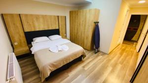 a bedroom with a bed with two towels on it at Kaya Residence in Uzungöl