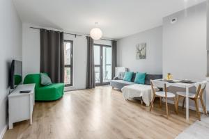 a living room with a couch and a table at Warsaw City Apartments in Warsaw