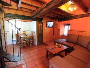 a living room with a couch and a table at Apartamentos La Corona in Parres de Llanes