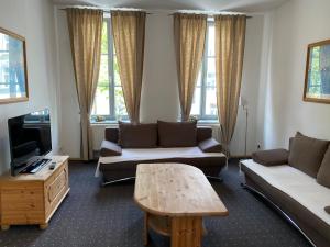 a living room with a couch and a coffee table at Pension Villa Ostseetraum in Warnemünde