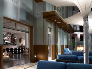 a lobby with blue couches in a building at Bungalow Hotel in Long Branch