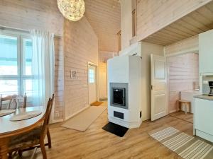 a kitchen and dining room with a fireplace and a table at Pikkulahden ranta in Kalajoki