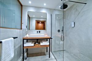 a bathroom with a sink and a shower at Golden Tulip Porto-Vecchio in Porto-Vecchio