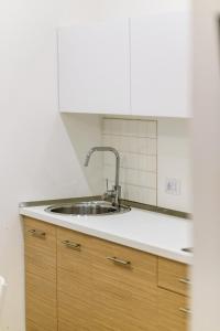 a kitchen with a sink and a white wall at HIDDEN GEM OLD TOWN APARTMENT by DuHomes in Dubrovnik +28 photos