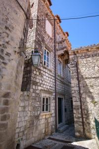 an old stone building with a street light on it at HIDDEN GEM OLD TOWN APARTMENT by DuHomes in Dubrovnik