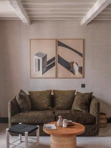 a living room filled with furniture and a painting on the wall at HOTEL SOOKIE in Paris