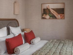 a hotel room with a bed and a painting on the wall at HOTEL SOOKIE in Paris